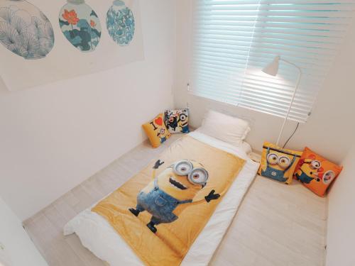 a bedroom with a bed with a cartoon character on it at Minionz House #Free parking in Seoul