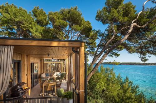 a cabin with a view of the water at Valamar Camping Padova in Rab