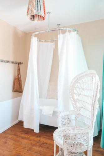 a room with a white chair and a window at Hôtel Lido Beach in Hyères