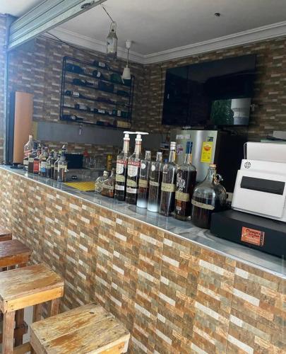 a bar with bottles of wine on a brick wall at Nouvelle Place in Trofwi