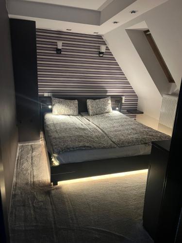 a bedroom with a bed with a large window at Apartament Stare Miasto Rynek Sienny in Szczecin
