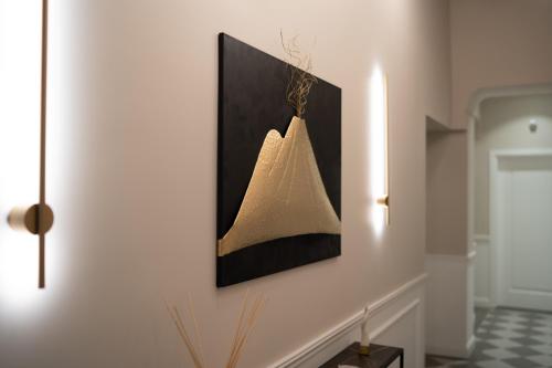 a picture hanging on a wall in a room at Monteroduni 22 - Chiaia Design Rooms in Naples
