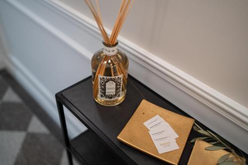 a small table with a bottle on top of it at Monteroduni 22 - Chiaia Design Rooms in Naples