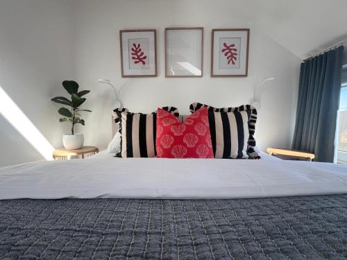 a bedroom with a white bed with pillows on it at Kapitan S in Gdańsk