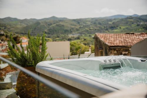 a bath tub with water coming out of it at Domus Polymnia, hospitality at its best! in Spílion