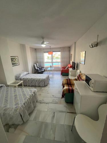 a large living room with two beds and a couch at Estudio junto al mar in Torrox Costa