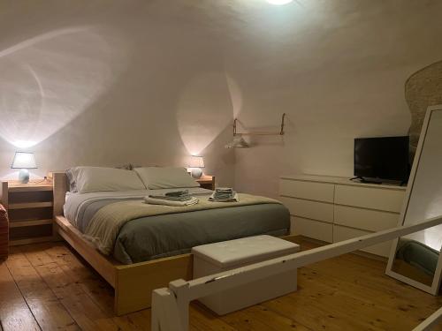 a bedroom with a bed and a television in it at Centrale56 in Bisceglie