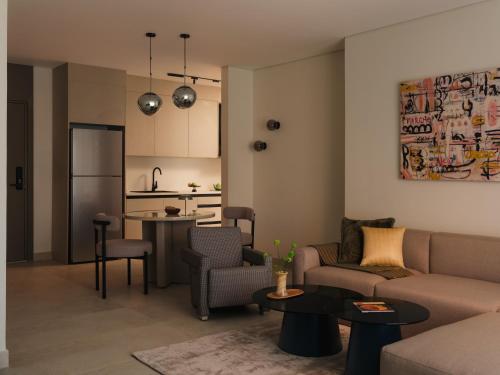 a living room with a couch and a table at Brassbell Zamalek Diplomatic Zone Near Marriott in Cairo