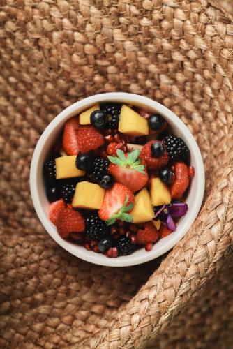 a bowl of fruit salad on a table at Enso District Hotel in Knokke-Heist