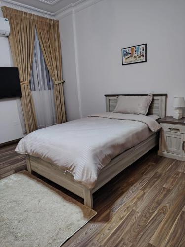 a bedroom with a bed and a television in it at Sada Compound (Women Only) سيدات فقط in Riyadh
