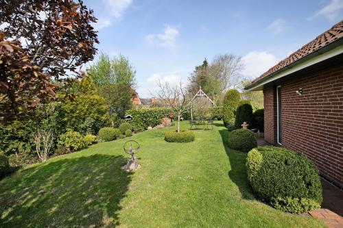 a garden with a statue in the grass at Ferienwohnung Martina in Leck
