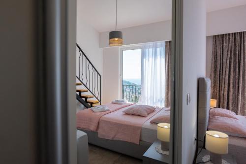 a bedroom with a bed and a large window at Ventus Rosa Villa in Budva