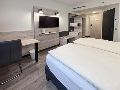 Postel nebo postele na pokoji v ubytování NEXTO DORMERO Hotel Budapest