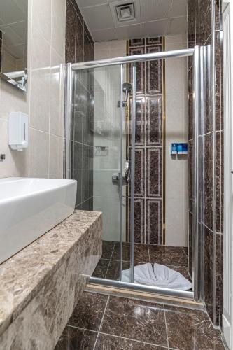 a bathroom with a shower and a sink at Hotel Black Tulip in Istanbul