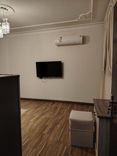 a living room with a flat screen tv on a wall at Sada Compound (Women Only) سيدات فقط in Riyadh