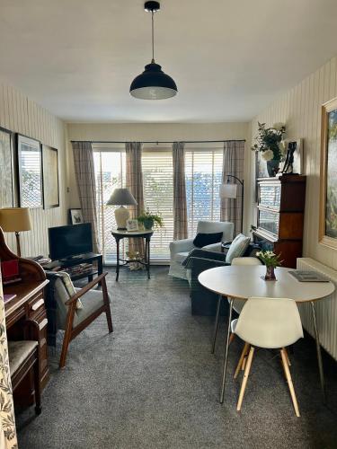 a living room with a couch and a table at Number 28a in Exmouth