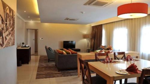 a living room with a couch and a table at Cresta Mahalapye Hotel in Mahalapye
