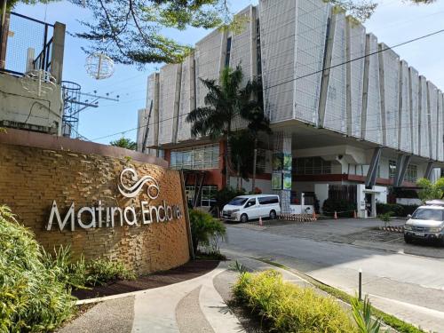 a sign in front of a building at Cozy 2bedrooms Matina Enclaves condo in Davao City