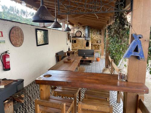 a room with a large wooden table with a letter at Quinta dos Milagres Chafariz 38 in Friumes
