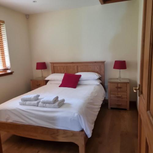 a bedroom with a bed with two towels on it at Cairngorm Lodges in Aboyne