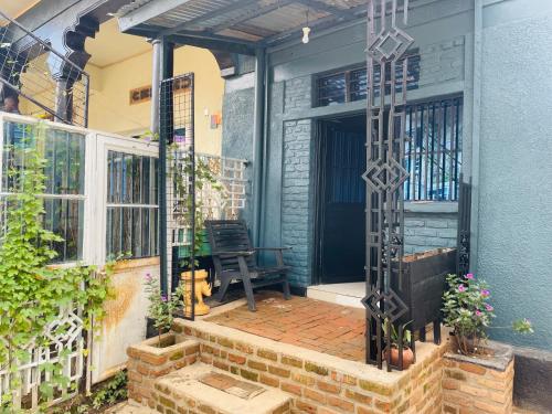 a front porch of a house with a bench at SAISH Stay in Ruhengeri