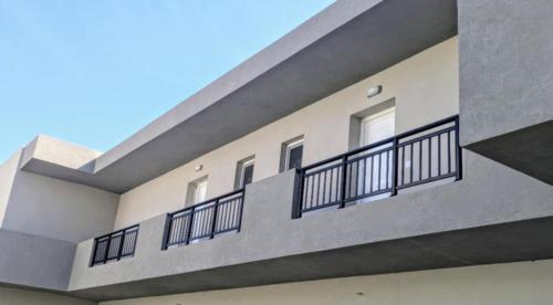 a building with balconies on the side of it at Lilac Kefalos in Kefalos