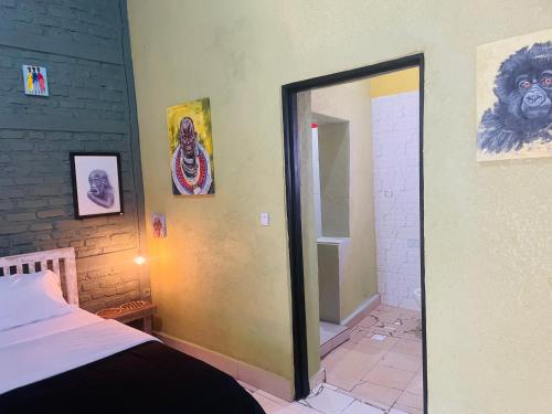 a bedroom with a mirror and a bed with a lion on the wall at SAISH Stay in Ruhengeri