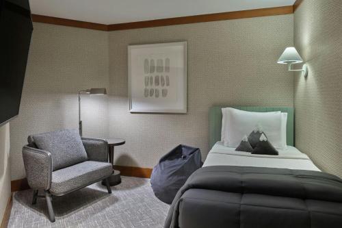 a hotel room with a bed and a chair at The Ritz-Carlton, Lake Tahoe in Truckee