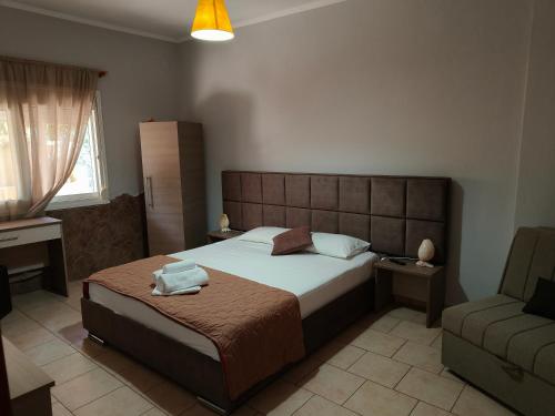a bedroom with a large bed and a couch at Villa Pavlina in Olympiada