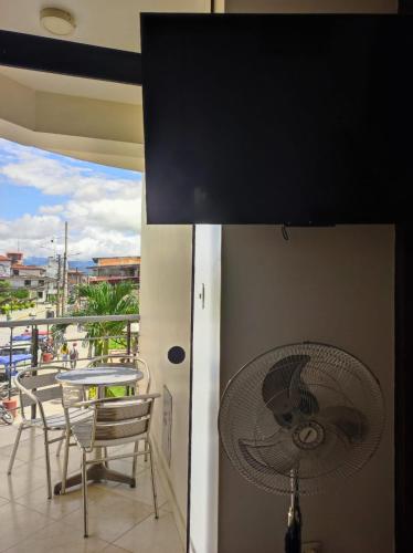 a fan on a balcony with a table and chairs at Borsalino Hostal in Rioja