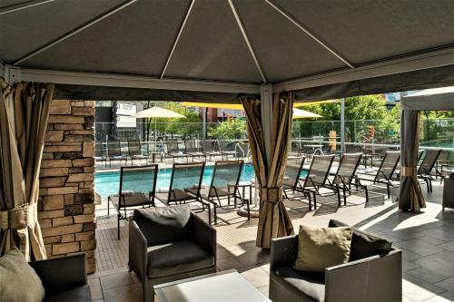a patio with chairs and a swimming pool at Delta Hotels by Marriott Kamloops in Kamloops