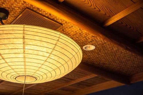 a light fixture hanging from the ceiling of a room at Yuyaruru Saisai in Kanazawa