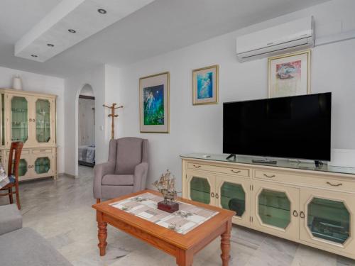 a living room with a television and a coffee table at Apartment Las Terrazas by Interhome in Marbella