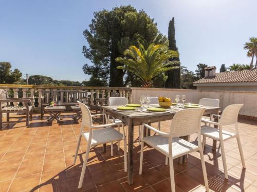 a wooden table and chairs on a patio at Holiday Home Serge by Interhome in Cambrils