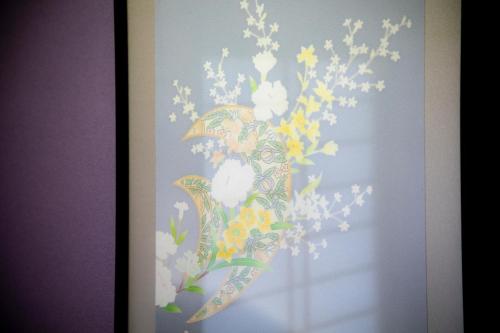 a painting of a bird with flowers on a wall at Yuyaruru Saisai in Kanazawa