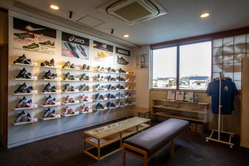 a room with a bunch of shoes on display at Yuyaruru Saisai in Kanazawa