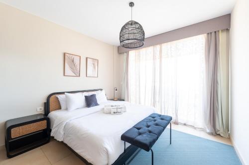 a bedroom with a large white bed and a window at El Gouna - BIRD NEST in Hurghada