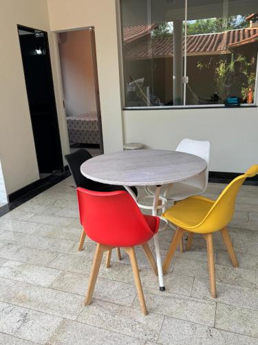 a table and four chairs sitting around a table at Suíte privativa próximo a Pampulha in Belo Horizonte