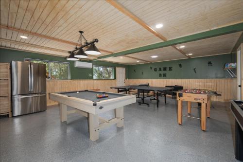 a ping pong room with ping pong tables in it at Yosemite Lookout Lodge w/ hot tub, firepits, game room, and more in Oakhurst