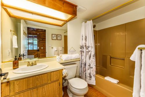 a bathroom with a sink and a toilet and a shower at Log Cabin w/ pool, spa, game room, sleeps 20 in Coarsegold