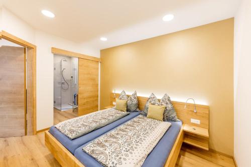 a bedroom with a blue bed and a shower at Weingut-Ferienwohnungen Kracher in Apetlon