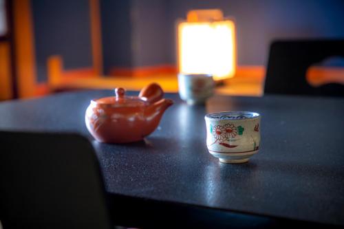 a bowl and a cup sitting on a table at Yuyaruru Saisai in Kanazawa