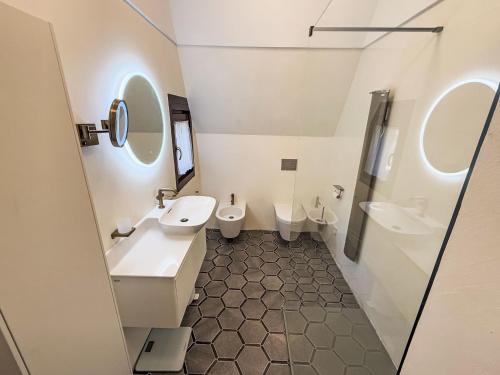 a bathroom with two sinks and two toilets at Apartment Vento Errante by Interhome in Dorio