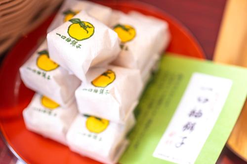 a bunch of rolls of toilet paper on a red plate at Yuyaruru Saisai in Kanazawa