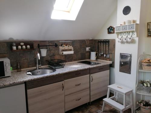 a kitchen with a sink and a counter top at NATURKERT Vendégház in Várvölgy