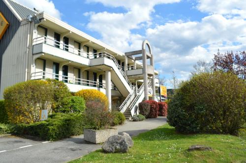 a white building with a staircase in front of it at Premiere Classe Chambery in Chambéry