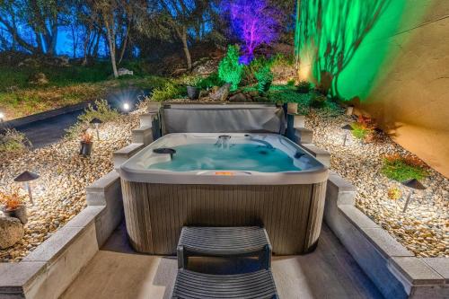 a jacuzzi tub in the middle of a garden at Big Oak Manor w/movie theater, hot tub, sleeping for 20! in Oakhurst