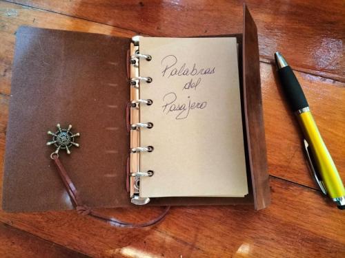 a notebook with a pen on a table with a penknife at La ermita del bosque in Valparaíso