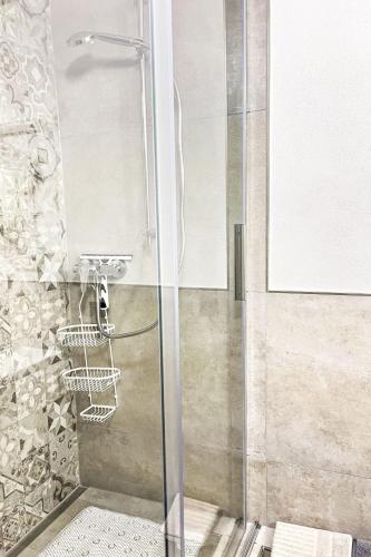 a shower with a glass door in a bathroom at Apartment Ferienwohnung Renata 1 nahe Nürburgring by Interhome in Quiddelbach