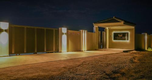 a building with a fence in front of it at night at GF Luxury Villa with indoor pool -Afytos in Afitos